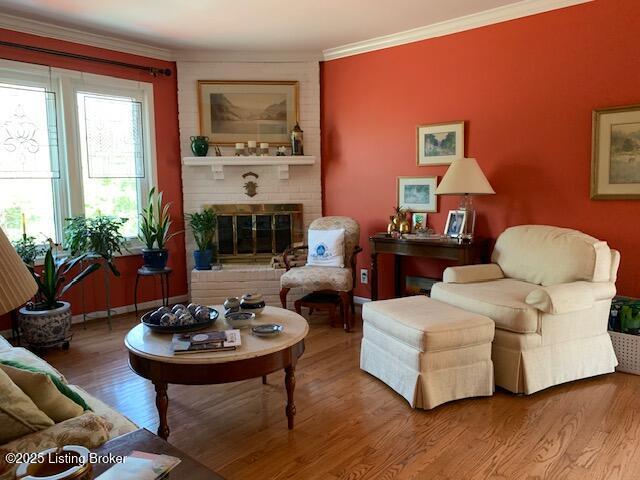 325 Rosewood Dr, Louisville, KY 40223 - sitting room with wood finished floors, crown molding, and a fireplace