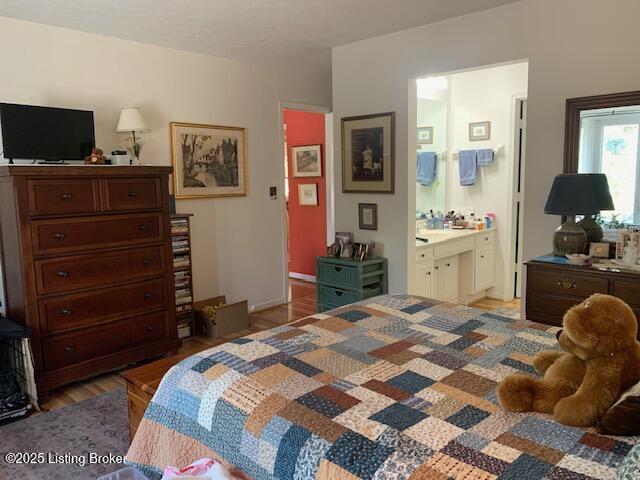 325 Rosewood Dr, Louisville, KY 40223 - bedroom with light wood-type flooring and ensuite bathroom