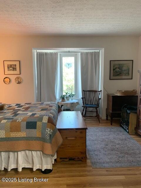 325 Rosewood Dr, Louisville, KY 40223 - bedroom with a textured ceiling and wood finished floors