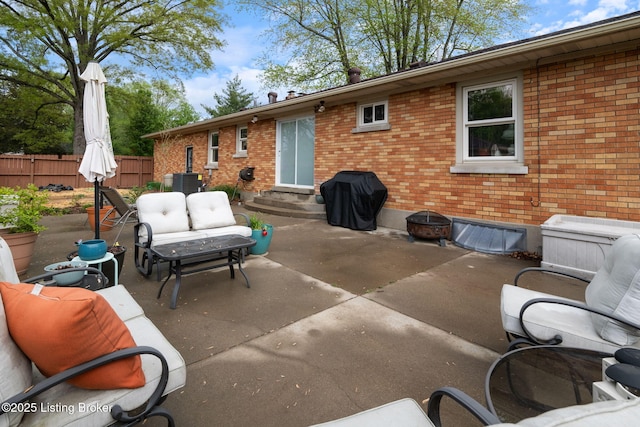 view of patio with grilling area, fence, outdoor lounge area, and entry steps