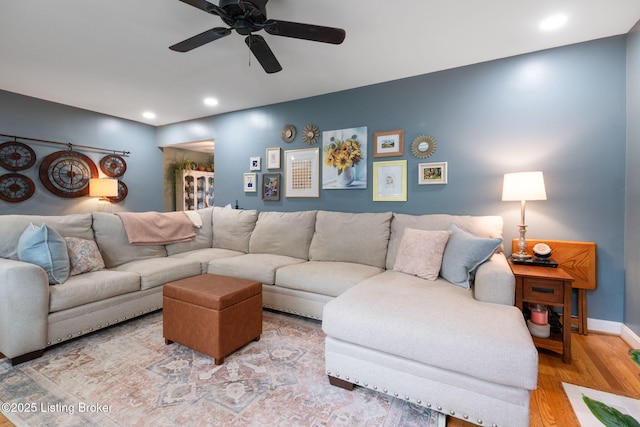 living area with ceiling fan, baseboards, light wood-style floors, and recessed lighting
