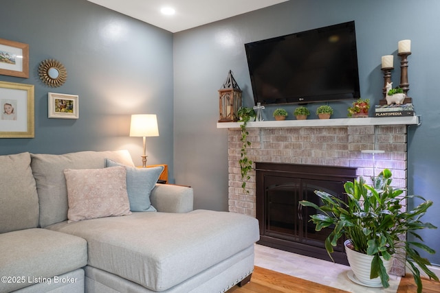 living room with a fireplace, wood finished floors, and recessed lighting