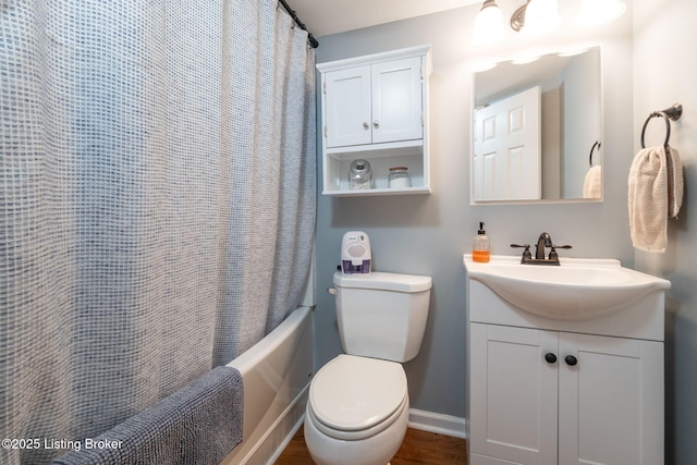 full bath with toilet, baseboards, shower / tub combo with curtain, wood finished floors, and vanity