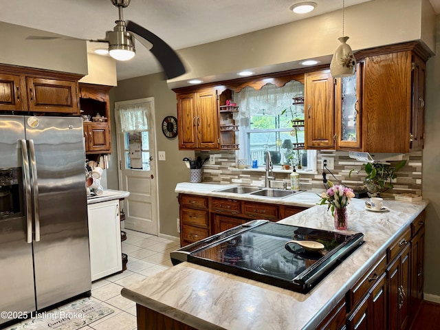 kitchen featuring open shelves, cooktop, a sink, stainless steel fridge with ice dispenser, and backsplash