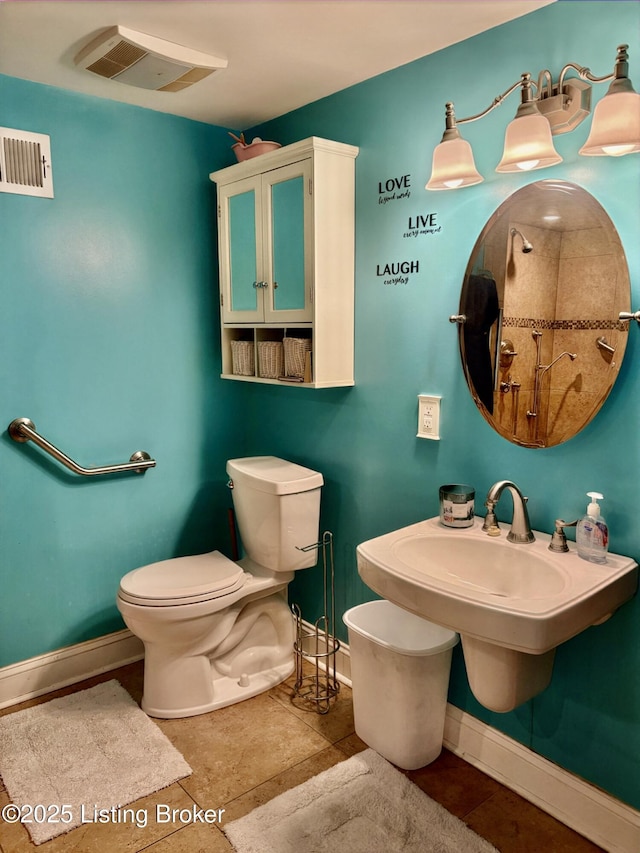 bathroom featuring visible vents, toilet, baseboards, and tile patterned floors