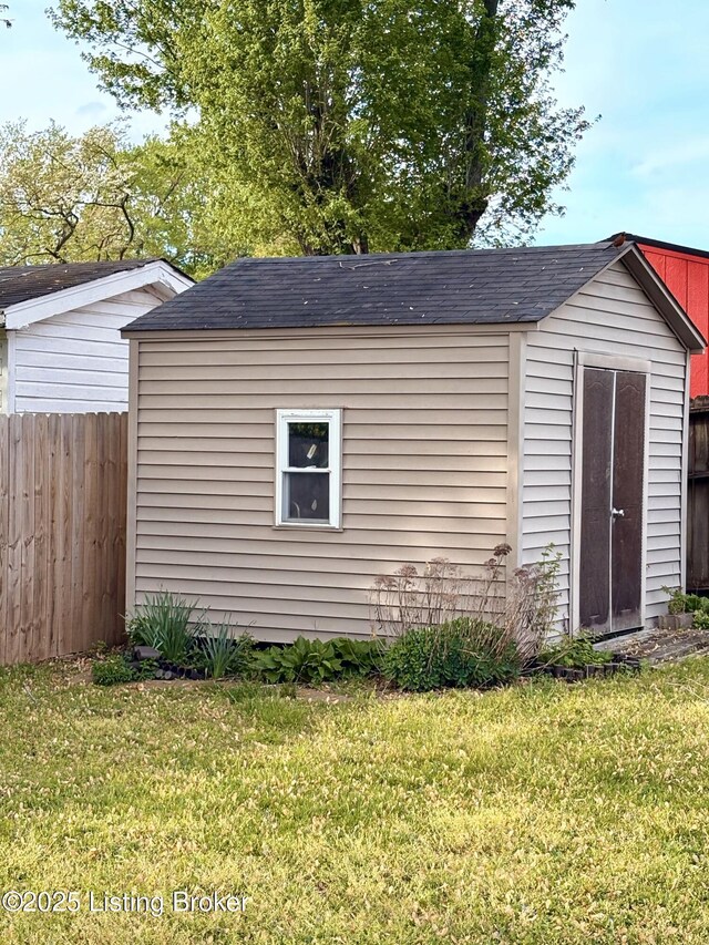 view of shed featuring fence