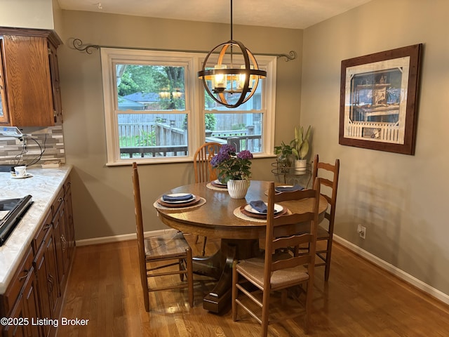 10210 Eve Dr, Louisville, KY 40272 - dining room featuring plenty of natural light, wood finished floors, baseboards, and a chandelier