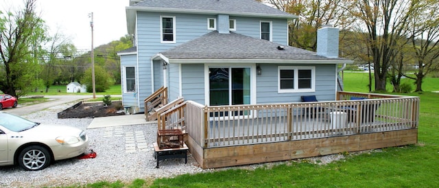 702 11th St, Carrollton, KY 41008 - rear view of property with a chimney, roof with shingles, a deck, and a yard