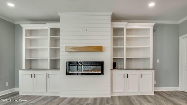 unfurnished living room with recessed lighting, baseboards, ornamental molding, and light wood-style flooring