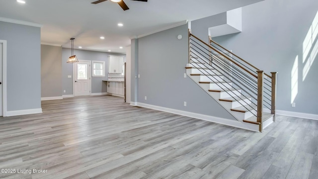 unfurnished living room with stairs, light wood-type flooring, ceiling fan, ornamental molding, and recessed lighting
