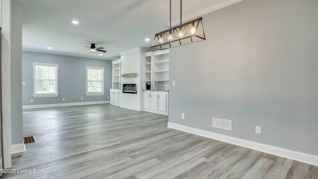 unfurnished living room featuring visible vents, ornamental molding, baseboards, and ceiling fan