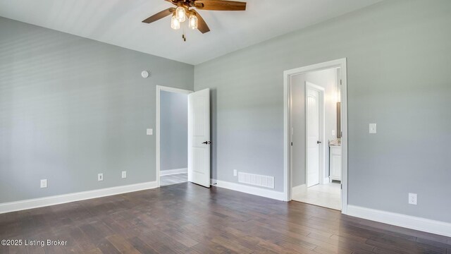 unfurnished bedroom featuring baseboards, visible vents, ceiling fan, and dark wood-style flooring