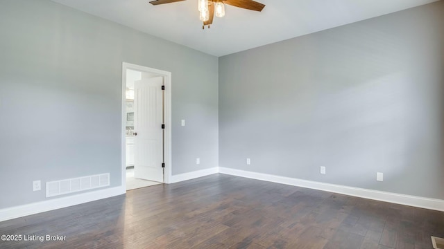 unfurnished room with visible vents, a ceiling fan, baseboards, and dark wood-style flooring