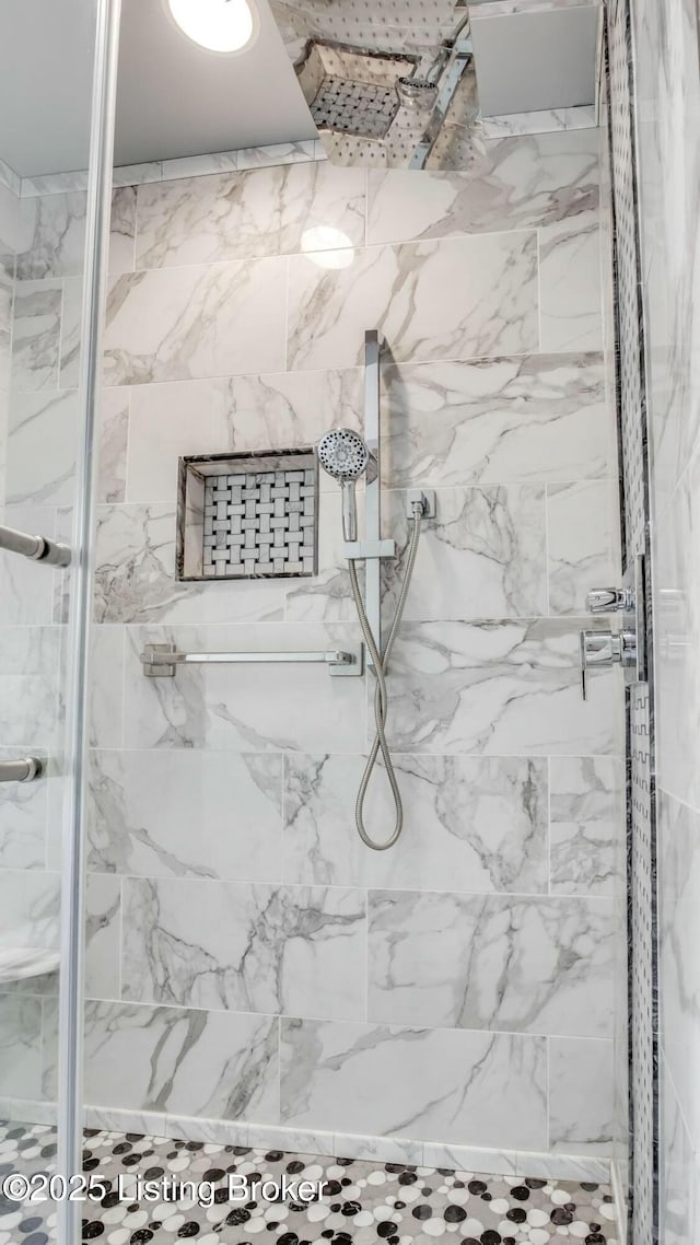 full bathroom with a marble finish shower