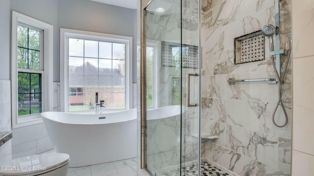 full bathroom with a marble finish shower, marble finish floor, a freestanding bath, and toilet