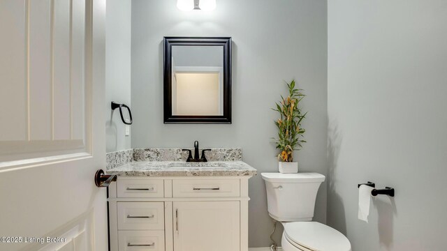 bathroom featuring toilet and vanity