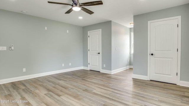 interior space with light wood finished floors, a ceiling fan, baseboards, and recessed lighting