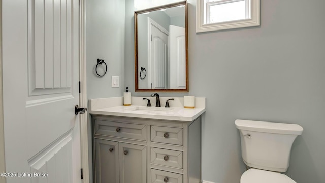 half bath with vanity and toilet