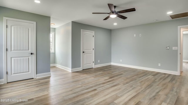 empty room with baseboards, a ceiling fan, wood finished floors, and recessed lighting