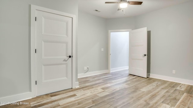 unfurnished bedroom featuring baseboards, visible vents, and light wood-style flooring