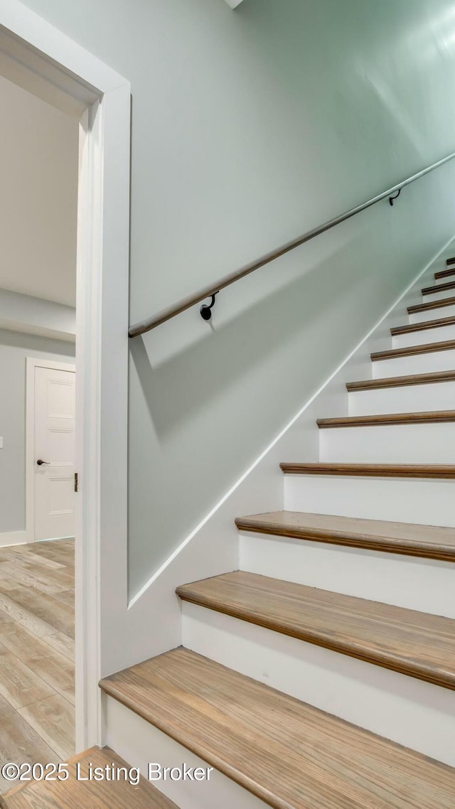 stairway with wood finished floors