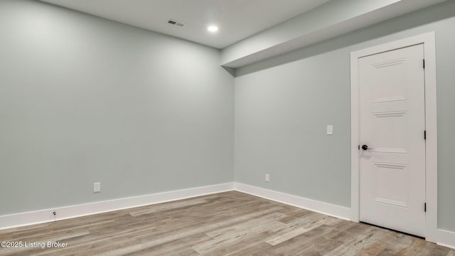 spare room featuring recessed lighting, light wood-style flooring, visible vents, and baseboards
