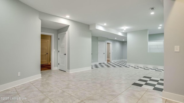 empty room with baseboards, visible vents, recessed lighting, and light tile patterned floors