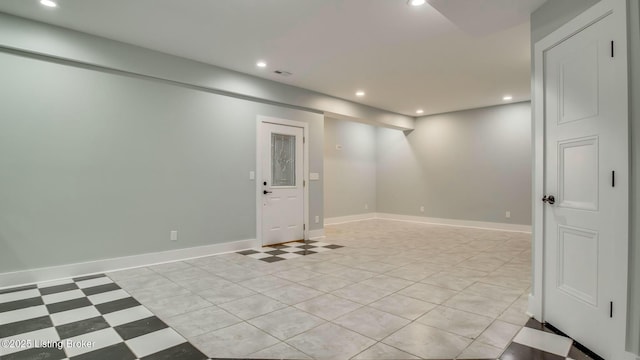 below grade area with baseboards, visible vents, and recessed lighting