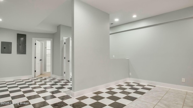 interior space with recessed lighting, electric panel, and baseboards