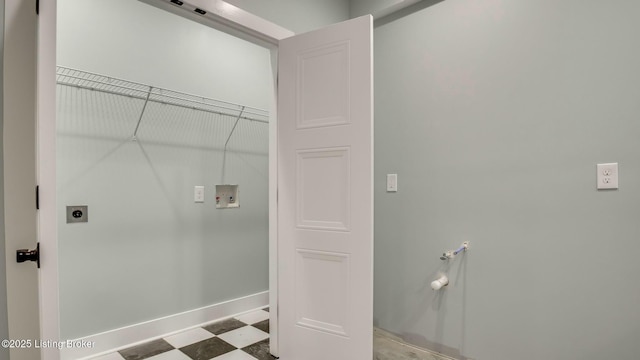 clothes washing area featuring tile patterned floors, laundry area, hookup for an electric dryer, hookup for a washing machine, and baseboards