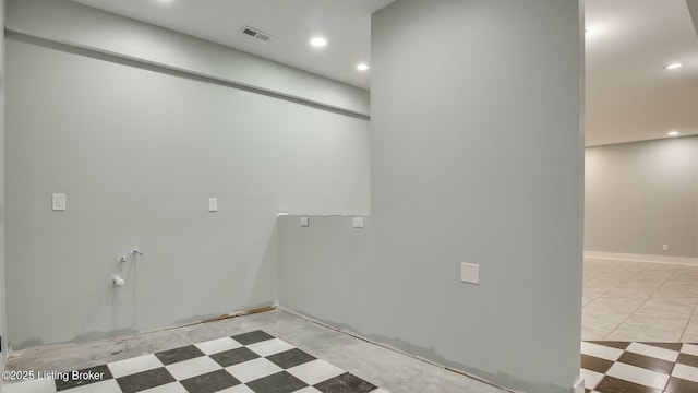 clothes washing area with visible vents and recessed lighting