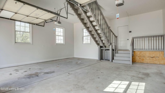 garage with a garage door opener and baseboards
