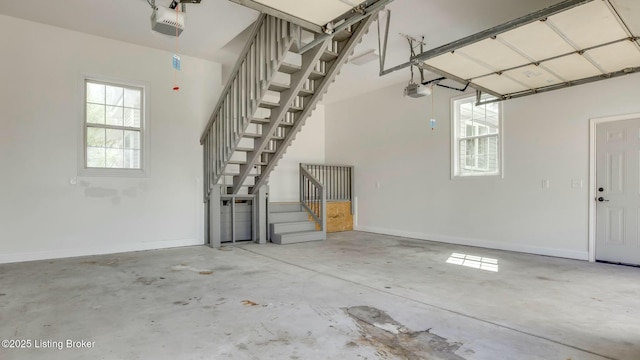 garage with a garage door opener and baseboards