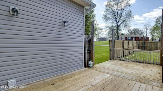 wooden terrace featuring a lawn