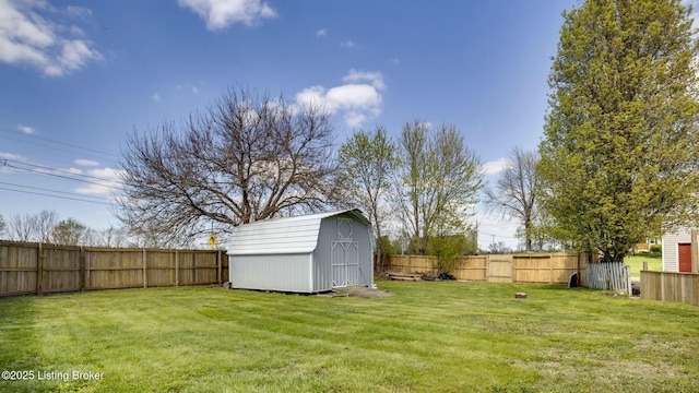 view of yard featuring a fenced backyard, an outdoor structure, and a shed
