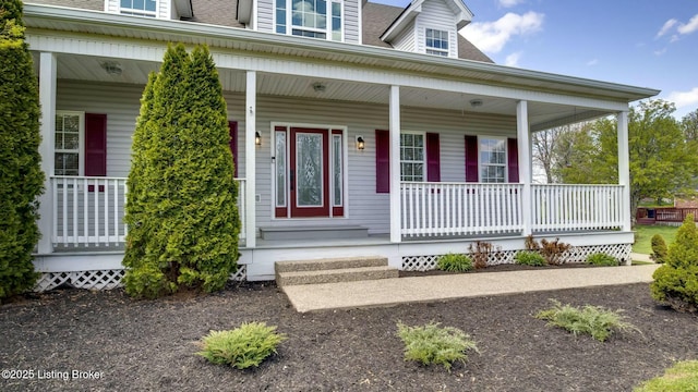 property entrance with a shingled roof and covered porch