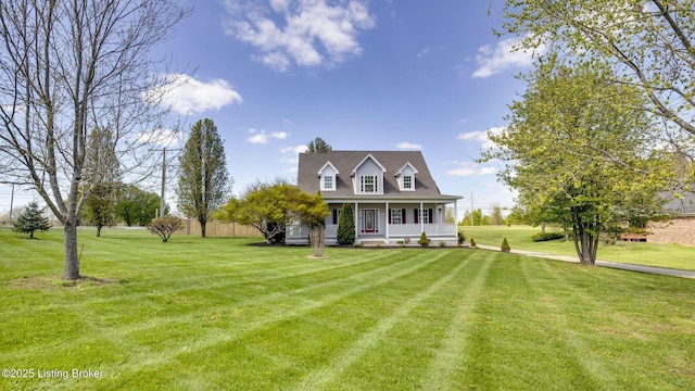 cape cod house featuring a front yard and covered porch
