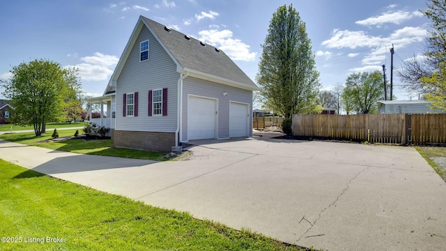 view of home's exterior featuring concrete driveway, fence, a yard, a garage, and brick siding