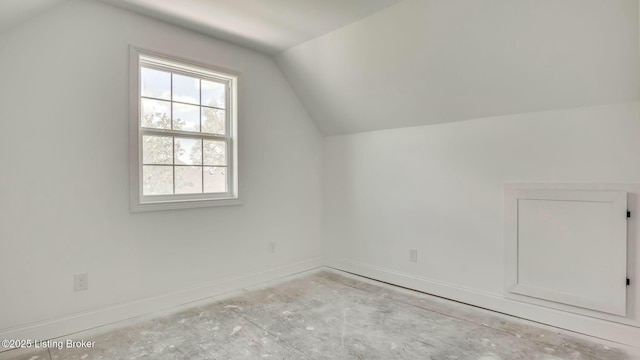 bonus room with vaulted ceiling, baseboards, and a wealth of natural light
