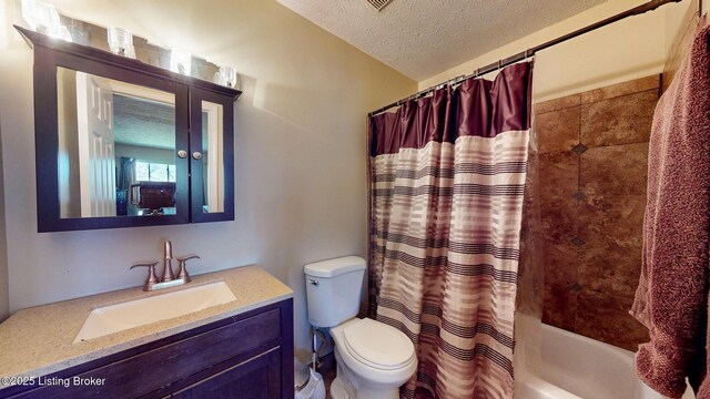 full bath featuring shower / bath combination with curtain, vanity, a textured ceiling, and toilet