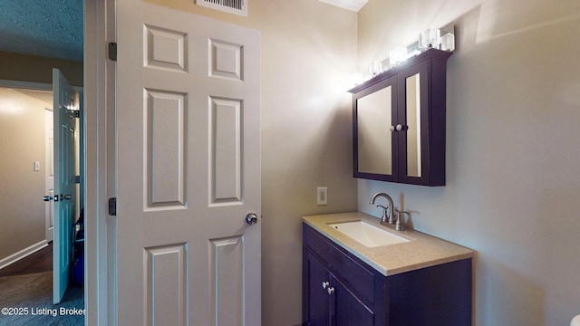 bathroom with vanity and visible vents