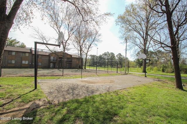 surrounding community featuring fence, a yard, and community basketball court