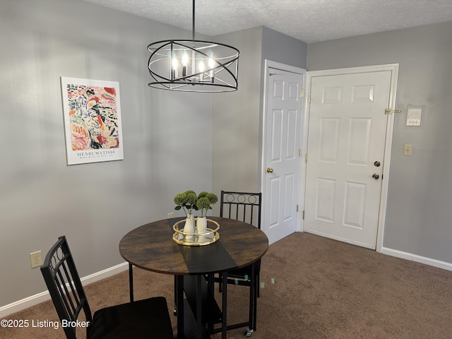 dining area featuring baseboards, carpet, a textured ceiling, and a chandelier