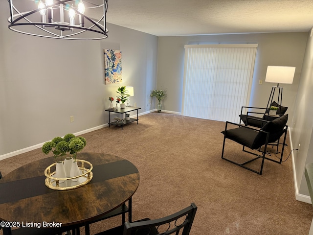 sitting room with baseboards, carpet flooring, and a notable chandelier