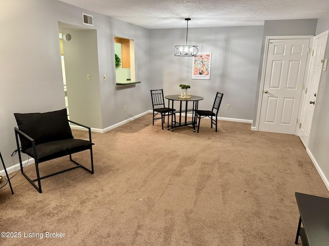 dining area with visible vents, carpet flooring, a textured ceiling, and baseboards