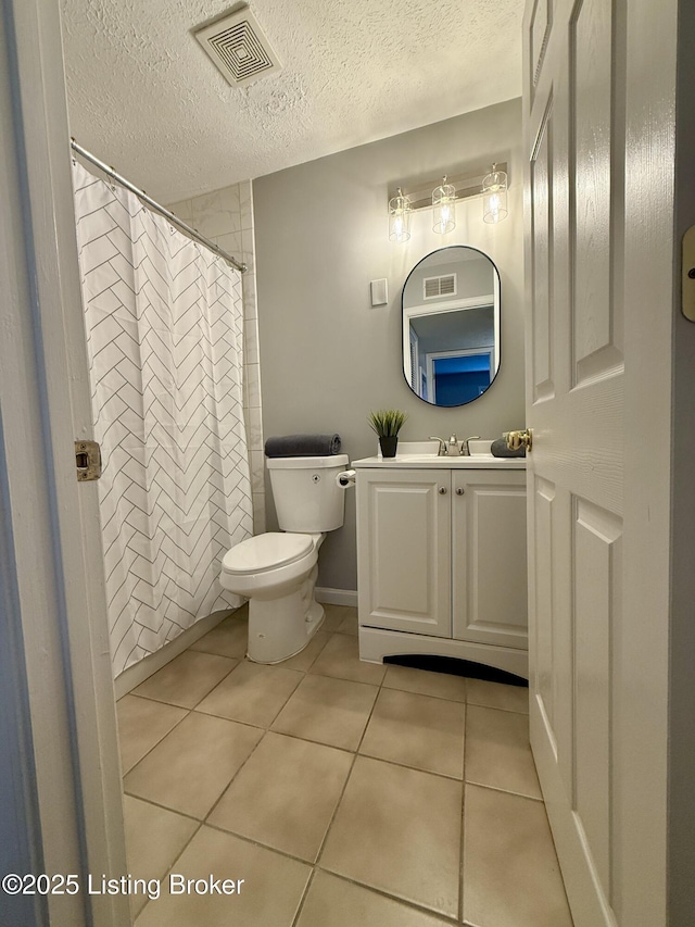 bathroom with visible vents, tile patterned floors, toilet, and vanity