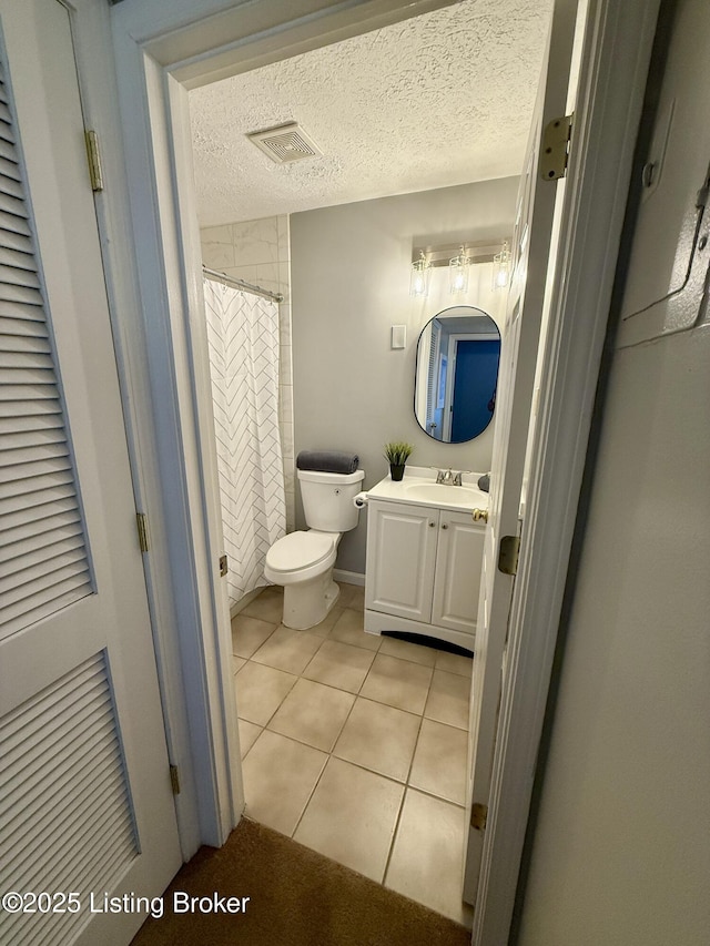 full bath featuring visible vents, tile patterned flooring, vanity, toilet, and a textured ceiling