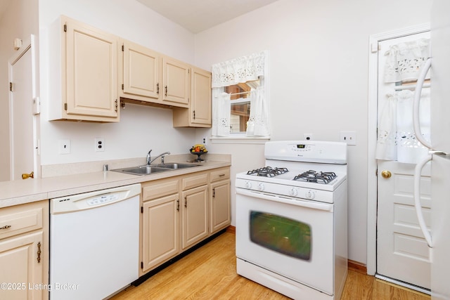 1035 Lydia St, Louisville, KY 40217 - kitchen featuring white appliances, a sink, light wood-style flooring, light countertops, and cream cabinets