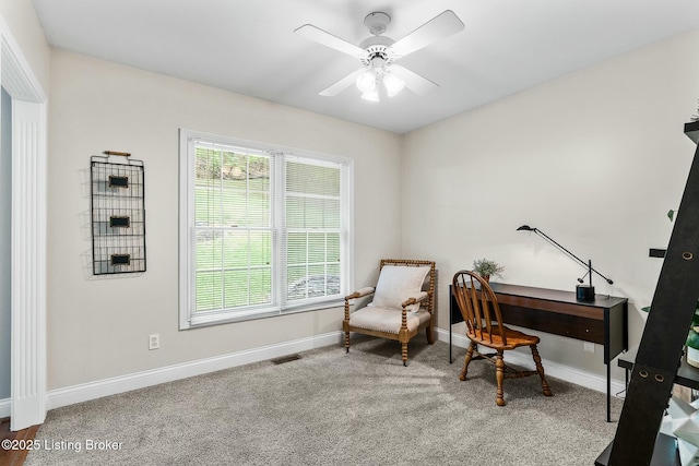 interior space with ceiling fan, visible vents, and baseboards