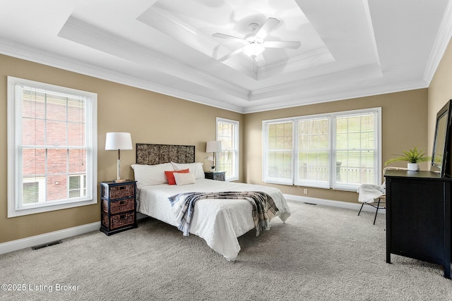 bedroom with a raised ceiling, a ceiling fan, visible vents, carpet, and ornamental molding